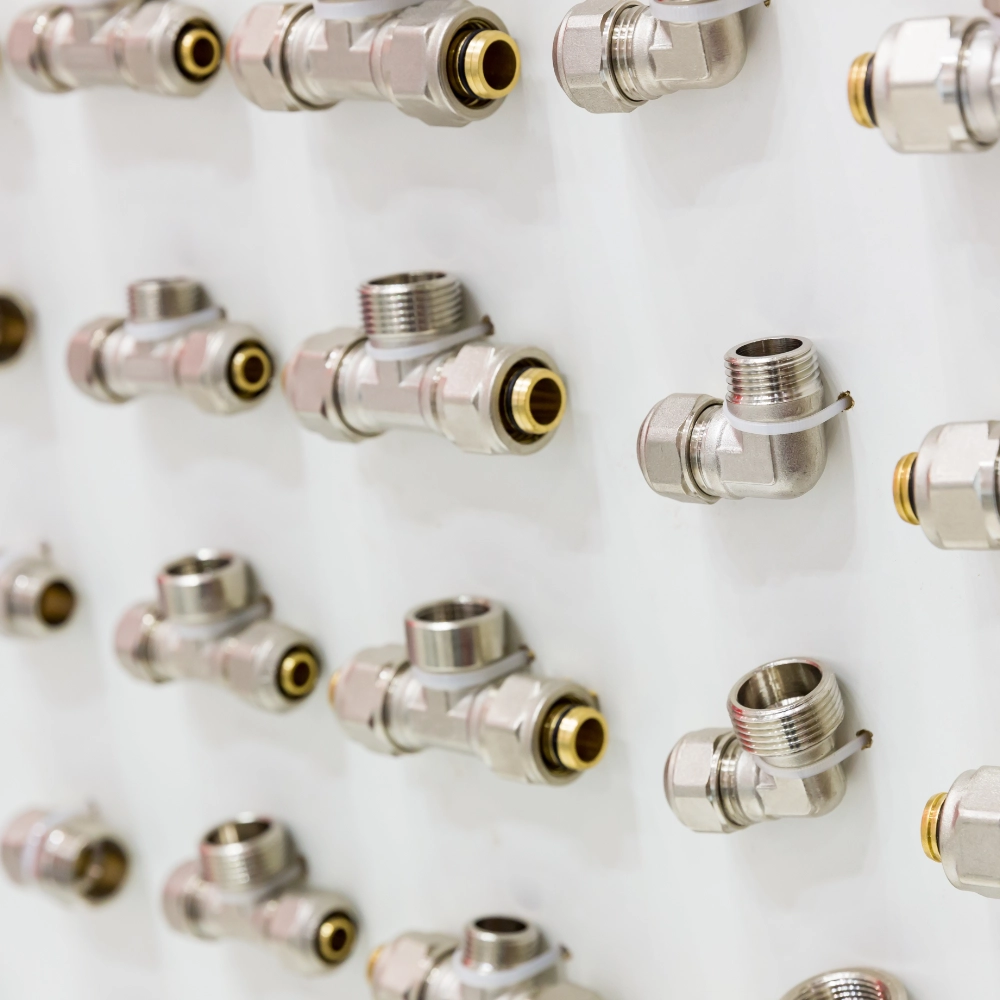 Assorted metal press fittings for plumbing and heating pipework