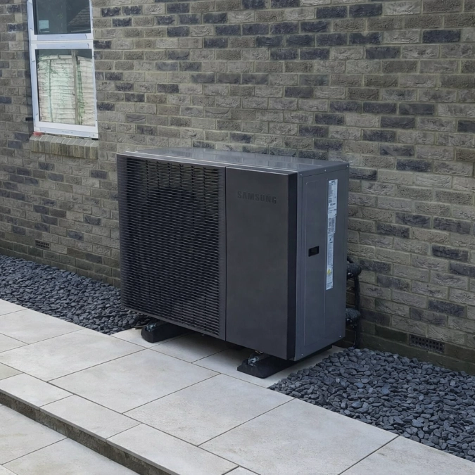 Samsung air source heat pump installed outside a brick-built property.