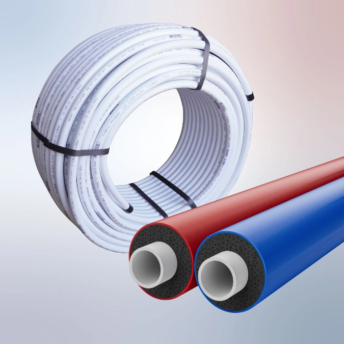 Coil of white plumbing pipe with red and blue insulated pipe sections shown in front.